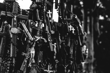 Numerous crucifixes on the hill of crosses in Lithuania. Black and white. Concept of death, despair, and destruction.
