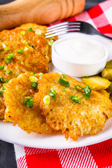 Delicious crispy potato pancakes on dark stone background
