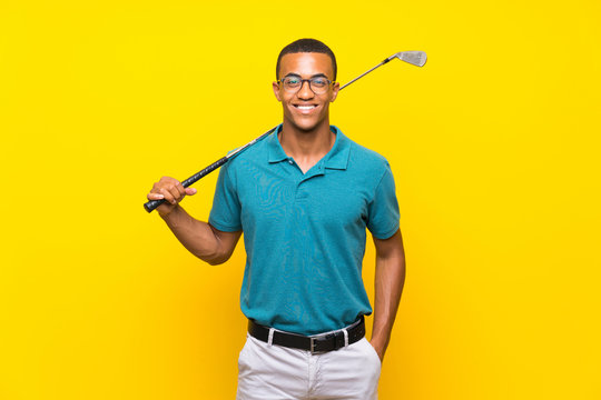 Afro American golfer player man over isolated yellow background