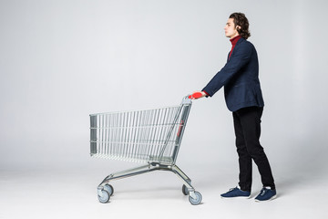 Businessman pushing a shopping cart on isolated white background