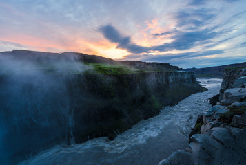 River leading away from the mighty dettifoss,  with steam in the background iceland, sunset
