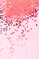 Pink background with red hearts. Valentine's day concept. Top view.