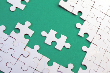 White puzzles on a green background