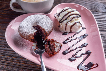 chocolate fondant with ice cream on wooden rustic background