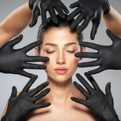 Face skin check before plastic surgery. Medical doctors are checking a face of a woman before botox...
