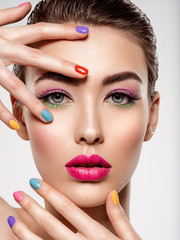 Beautiful fashion woman with a colored nails. Attractive white girl with multicolor manicure.