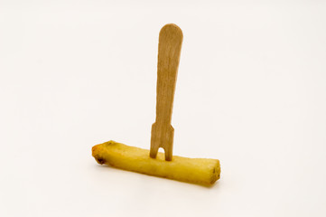 Wooden fries fork on a baked french fries