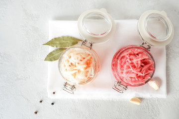 Homemade sauerkraut with carrots and coleslaw with beets on the table. View from above. Copy space.