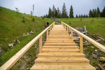 Obraz premium New wooden stairs outdoors. Carpenters work.