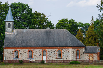Fototapeta premium An old 18th-century church built of stones in the small town of Kaltene in Latvia.