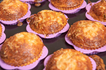 cupcakes in pink silicon moulds, on a black tray
