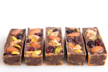 brown chocolate sticks with nuts, pistachios and candied fruit