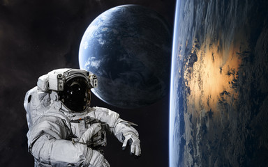 Astronaut on background of planets in deep space. Science fiction. Elements of this image furnished...