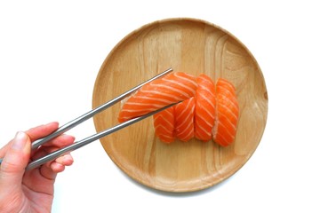 Top eye view closeups of delicious sliced salmon sushi sashimi five bite for serving isolated on  wooden background a