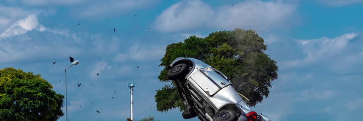car crashed after an accident flies in the air with shards.