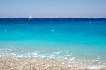 Turquoise water of mediterranean sea on Elli beach on Rhodes island in Greece