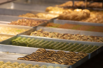 The sherbet sweets on the trays in the shop selling baklava. Closeup.