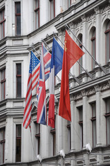 flags of the of the four victorious powers, the USA, Great Britain, France and the Soviet Union on a house wall in Berlin