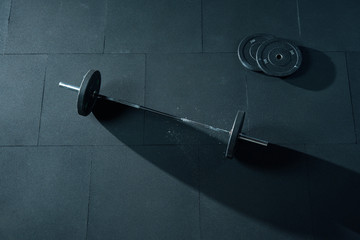 Barbell with weights plate on floor. A set of heavy barbells sitting on a gym floor Fitness...
