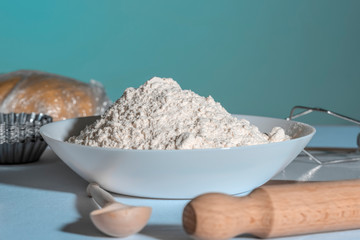 Plate with flour on the table before cooking pastry.