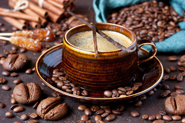 Tasty cookies and cup of aromatic coffee on  dark table