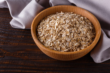 raw oatmeal on a wooden rustic background