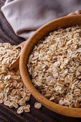 raw oatmeal on a wooden rustic background