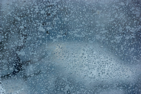 water drops on the frozen fogged glass of the car