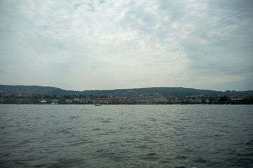 Charming panoramic scene of Zurich town looking from boat on limmat river with cloudy sky background , copy space , Switzerland