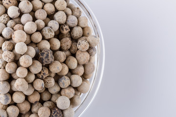 white peppers in glass bowl on white background