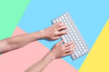 Fototapeta na wymiar Woman using a computer keyboard - overhead view