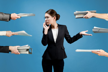 A business woman is distracted by employees on various issues