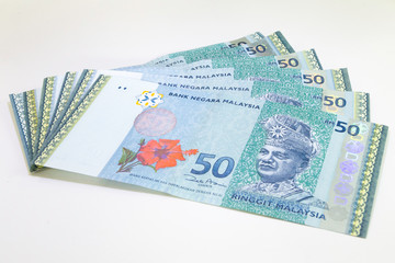 Malaysia Currency (MYR): Stack of Ringgit Malaysia bank note. There is a Malaysia banknotes in (MYR)50 isolated on white background