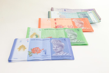 Malaysia Currency (MYR): Stack of Ringgit Malaysia bank note. There is a Malaysia banknotes in (MYR)1, (MYR)5, (MYR)50 and (MYR)100 isolated on white background