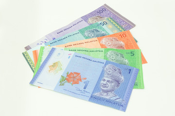 Malaysia Currency (MYR): Stack of Ringgit Malaysia bank note. There is a Malaysia banknotes in (MYR)1, (MYR)5, (MYR)50 and (MYR)100 isolated on white background