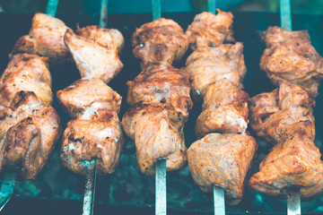smoked fried food, barbecue bbq, grilled meat, kebab. Close up barbeque on metal skewers, pieces of pork on metal skewer, grill.