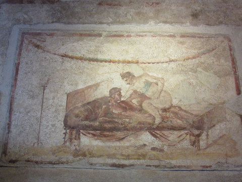 View of painted poses on the wall of the brothel located in Pompeii, Italy 