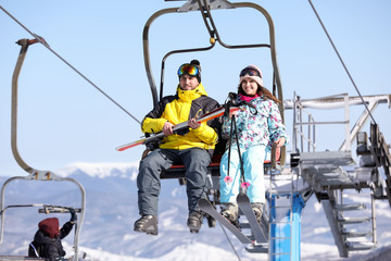 Fototapeta na wymiar People using chairlift at mountain ski resort. Winter vacation