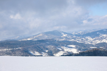 Picturesque view of snowy hills at mountain resort