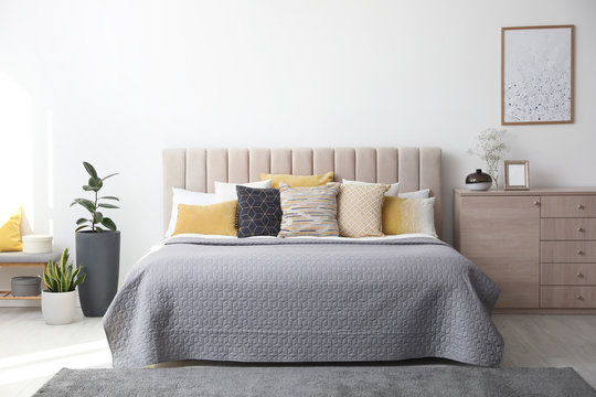 Stylish interior of contemporary room with comfortable bed