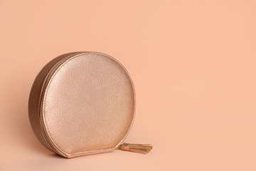 Stylish woman's bag on pale pink background. Space for text