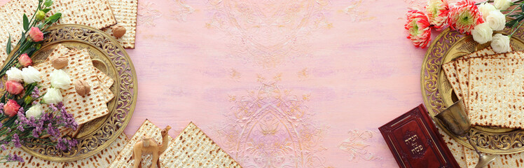 Pesah celebration concept (jewish Passover holiday). Traditional book with text in hebrew: Passover...