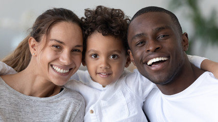 Head shot portrait smiling African American mother, father and son