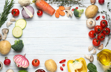 Flat lay composition with fresh products on white wooden table, space for text. Healthy cooking