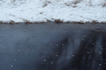 Asphalt cleared of snow by salt.
