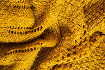 Orange knitted background. Close up gray fabric texture background. wrinkled and shadows, selective focus top view
