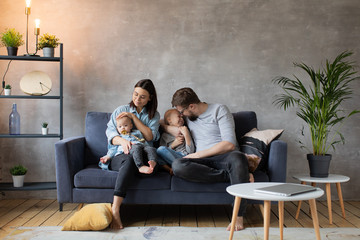 Obraz premium Young Family Playing Together on the Sofa. happy family. home comfort.
