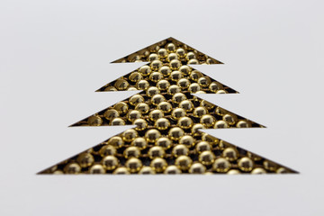 Christmas tree made of beads and paper. White stencil
