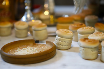The liturgical liturgical bread of Prosphorus, Prosphora used during Orthodox worship. Preparation for Holy Communion. hands of the priest, icons placed on the altar of the Orthodox Church. The concep
