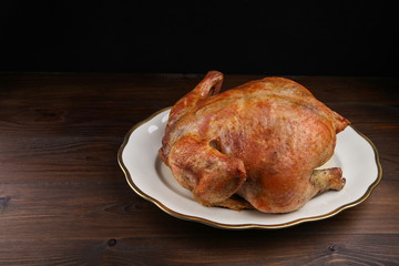 baked chicken on a dark wooden background with copy space